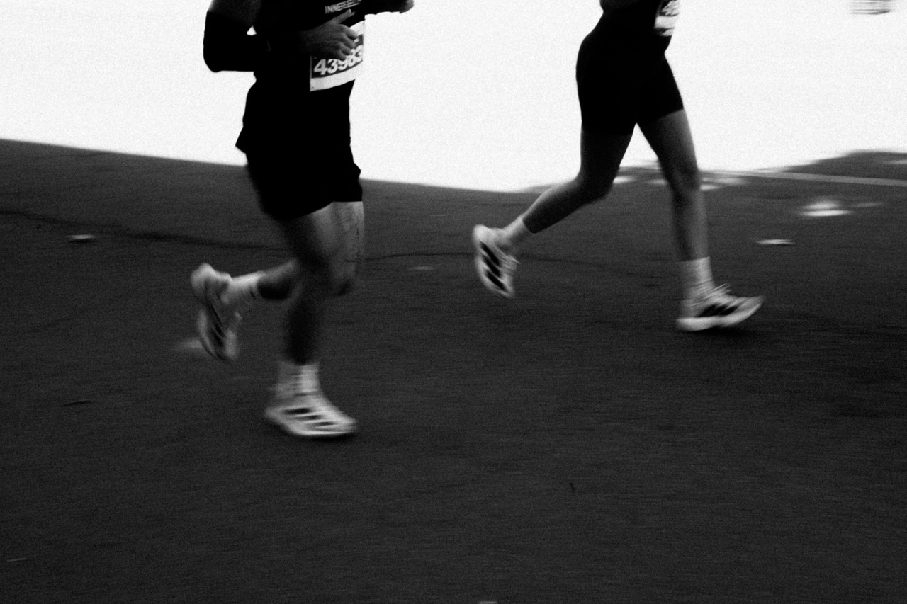Two runners training together at night